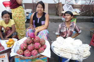 Women in downtown Yangon selling dragonfruit